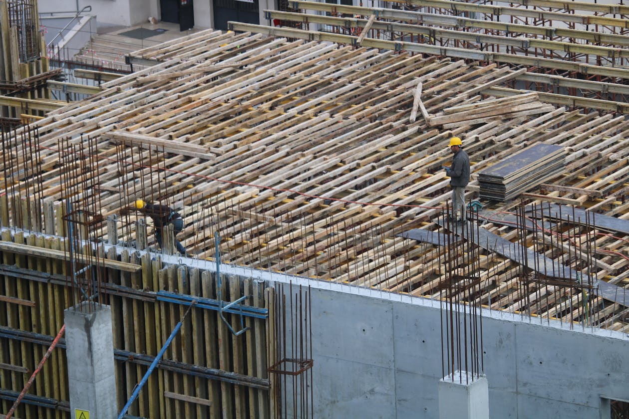 Men working on a construction site in Istanbul, with visible rebar and reinforcement structures. — decorative concrete overlay